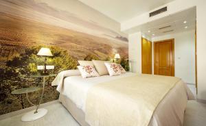 阿尔卡拉拉雷亚尔托瑞帕玛酒店的一间卧室配有一张壁画床