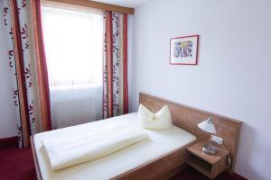 佩格尼茨佩格尼茨拉特斯图伯酒店的卧室配有白色的床和窗户