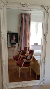 伊普霍芬DAS KLEINE HOTEL IPHOFEN, Iphofens kleines Secret的镜子反射着一间卧室,卧室配有床和椅子