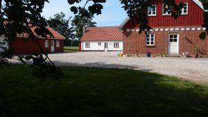 Funder KirkebyBjældskovgaard Holiday House的红色和白色的建筑,有红色屋顶