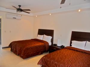 利比里亚埃斯普埃拉斯酒吧餐厅酒店的酒店客房配有两张床和吊扇。
