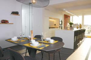 克诺克－海斯特B2B Luxury Apartments Hotel Services Included的一间带桌椅的用餐室和一间厨房