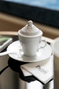 罗马Parisii Luxury Relais Rome的桌上的汤匙,白杯和碟子