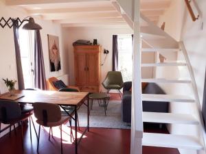 羊角村Huisje Beukers的配有桌椅和楼梯的房间