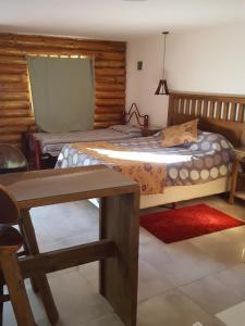 乌斯帕亚塔卡瓦尼亚斯廊奎兰开山林小屋的卧室配有一张床和一张桌子
