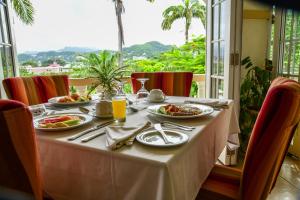 圣乔治蓝色地平线花园度假酒店的餐桌上放有食物盘子的桌子