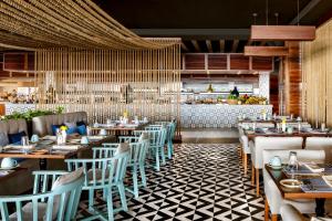 卡波圣卢卡斯Grand Velas Los Cabos Luxury All Inclusive的餐厅设有木桌、椅子和柜台