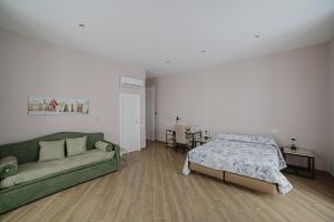那不勒斯B&B Galleria Principe di Napoli的客厅配有绿色沙发和床。
