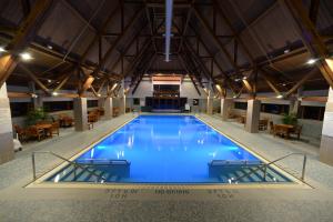 哥德伍德Alyeska Resort的一座带桌椅的大型游泳池