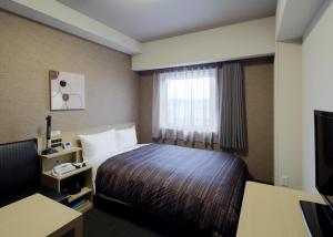 Hotel Route-Inn Grand Ota Ekimae客房内的一张或多张床位