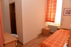 莫伊科瓦茨Hotel Dulovic的小房间设有床、桌子和窗户
