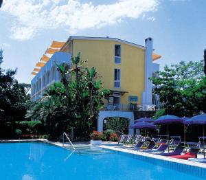 伊斯基亚圣吉凡尼特尔米酒店的一座带椅子的游泳池以及一座建筑