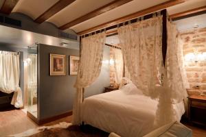拉瓜迪亚洛斯帕拉赫斯酒店的卧室配有带白色窗帘的天蓬床