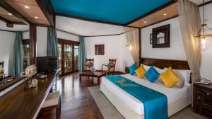 卡卢特勒皇家棕榈海滩酒店的一间卧室配有一张床、一张书桌和一台电视