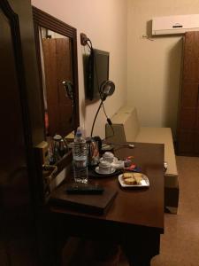 巴勒贝克卡纳安集团酒店的一张桌子,上面有一瓶水和一盘食物