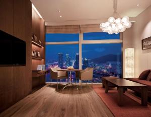 釜山釜山柏悦酒店的客厅设有桌子和大窗户