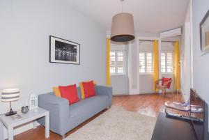 波尔图波尔图御花园公寓的客厅配有蓝色沙发和橙色枕头。