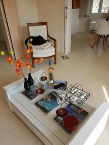 卡西斯LOU CIGALOU的客厅配有玻璃桌和花瓶