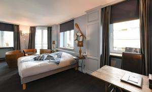 克诺克－海斯特德劳里埃住宅酒店的卧室配有一张床、一张书桌和窗户。