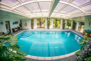 海斯廷斯Badgers Den - Covehurst Bay Holiday Cottage的一个带玻璃天花板的室内游泳池