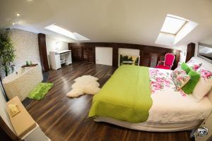 奥古斯图Elegancki loft w centrum.的一间卧室配有一张带绿毯的大床
