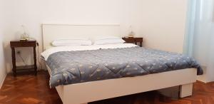 乌马格Apartments Milica的一张床位,房间设有两个床头柜和一张四柱床