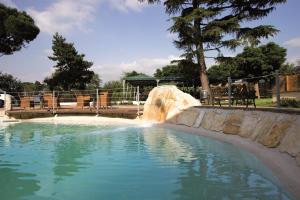 弗拉斯卡蒂Domus Park Hotel & SPA的公园内一个带水滑梯的游泳池