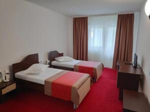 卡库拉塔Hostel Caliman的酒店客房配有两张床和一张书桌