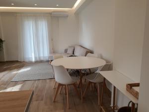 科孚镇Apartment Laoura的一间配备有白色桌椅的用餐室