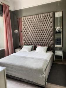 利沃夫Fountain Appartement的一间卧室配有一张大床和大床头板