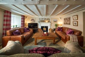 斯特灵Thornhill Lodge, Historic 4 Bed, 4 Ensuite的客厅配有真皮沙发和茶几