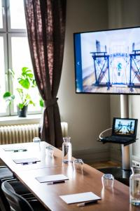 于默奥格姆拉番格尔塞特酒店的一间会议室,配有桌子和电视