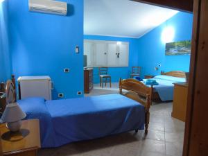 卡布拉斯Casa da Pina的一间拥有蓝色墙壁的卧室,配有一张床和一张桌子