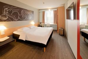 耶拿耶拿霍兹马克特宜必思酒店的酒店客房带一张大床,带白色床单