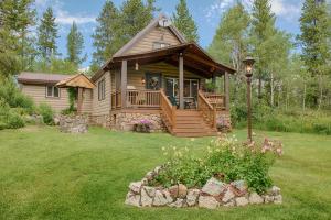 艾兰帕克Grandma's Cabin Yellowstone Vacation Home的小木屋设有甲板和门廊