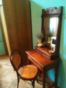 安布罗劳里AMBROsador的一张带镜子和椅子的木桌