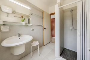 斯哥利提I Giardini di Athena- Athena Resort的白色的浴室设有水槽和淋浴。