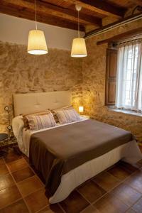 ZazuarCasa Rural Puerto Sanz的一间卧室配有一张带两个灯的大床