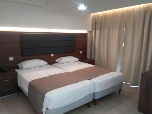 普罗塔拉斯里瓦斯公寓酒店的一间卧室配有一张大床和电视