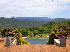 Vall de Bianya马斯普拉特乡村Spa酒店的享有游泳池和山脉景致的甲板