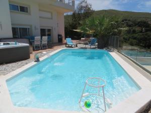 苏尼翁Thimari Sports & Spa with private pool and jacuzzi的一个带椅子的大型游泳池
