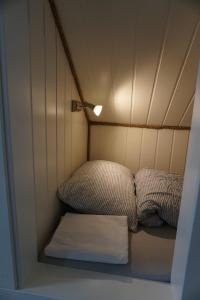 VarangerbotnVaranger Fisherman's Shed的小房间设有两张床和一盏灯