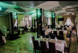 皮特什蒂Hotel Sorelo的一间带桌椅和鲜花的用餐室