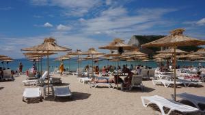 布尔加沃Вила Калиакра - Villa Kaliakra - 3 km to beach Bolata的海滩上摆放着椅子和遮阳伞,还有人