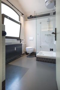 吕伐登Alibi Hostel Leeuwarden的带淋浴、卫生间和盥洗盆的浴室