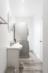 蒙特利尔Apartments Near Montreal Olympic Park的一间带水槽和冰箱的浴室
