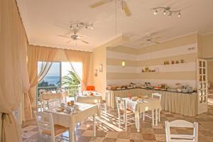 阿基奥斯·伊奥尼斯·佩里斯特Aurora Beach Hotel的带桌椅的房间和厨房