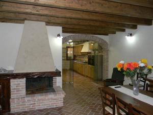 VillamassargiaAgriturismo Battaglia的厨房以及带砖砌壁炉的客厅。