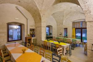 奥斯图尼Masseria Ferri的一间在房间内配有桌椅的餐厅