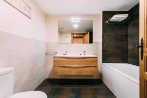 萨尔维塞Casa Rural Monte Perdido的一间带水槽、浴缸和卫生间的浴室